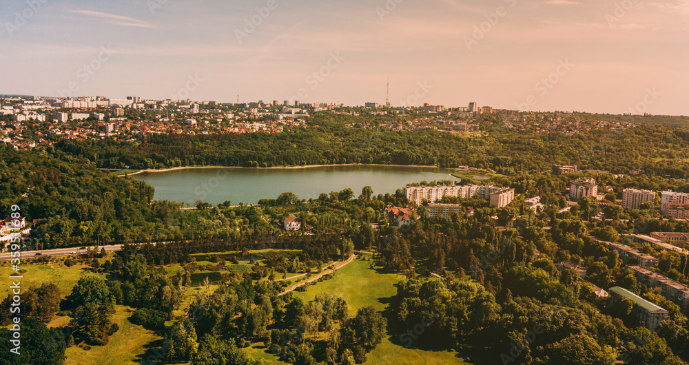 Landscape photo of beautiful city during sunset and amazing lake in center.