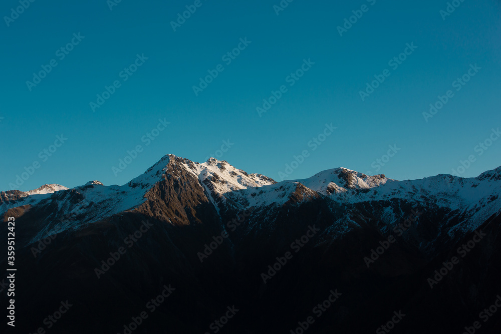 Panorama of Snow Mountain Range Landscape with dramatic sky in New Zealand.