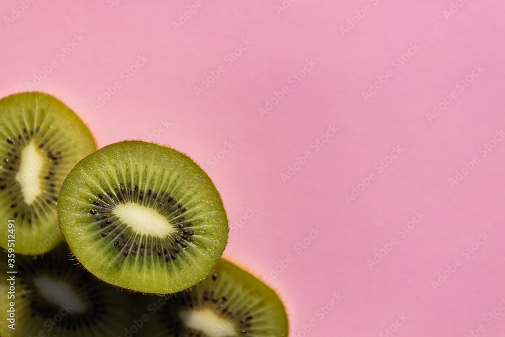 Kiwi fruit Slices macro. Ripe Kiwi fruit isolated on pink background. pace for text, blank. Layout. Background for text