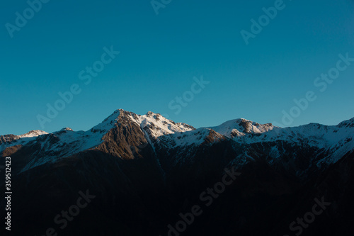 Panorama of Snow Mountain Range Landscape with dramatic sky in New Zealand.