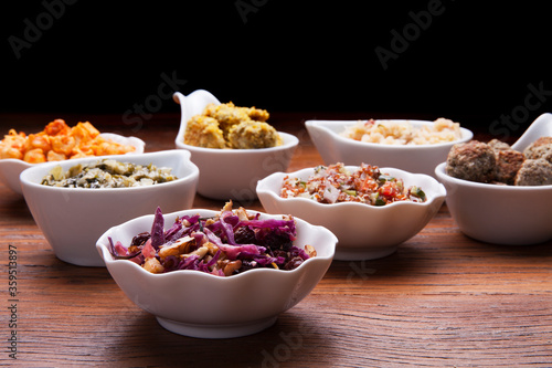Nutrition concept - Healthy meals in white bowls over wooden background. Healthy food, Diet, Detox, Clean Eating or Vegetarian concept. 