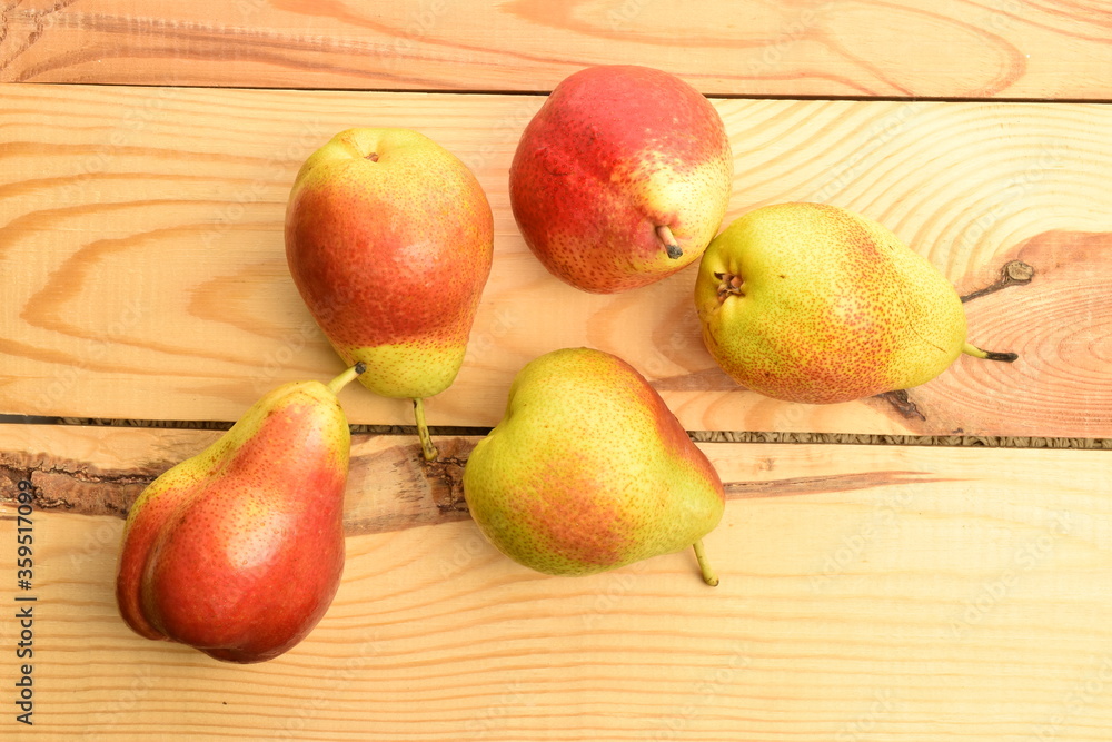 Organic juicy pears, close-up, on a wooden table.
