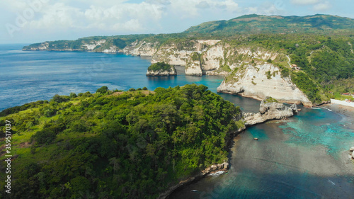Aerial view of the small island of Nusa Penida Island from the Atuh Rija Lima shrine on Nusa Penida Island near Bali, Indonesia. Nusa Penida island aerial view beach from drone.
