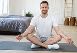 Man Meditating Sitting In Lotus Position Relaxing At Home