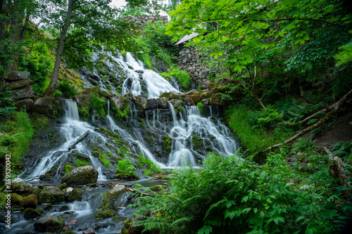 Long Exposure Waterfall in Lush Forest by the Old Watermill In rural Village Rottle By near Granna In Swedish Smaland, Sweden.  photo