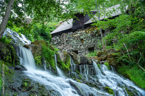 Long Exposure Waterfall in Lush Forest by the Old Watermill In rural Village Rottle By near Granna In Swedish Smaland, Sweden. 