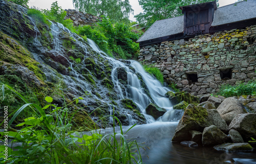 Long Exposure Waterfall in Lush Forest by the Old Watermill In rural Village Rottle By near Granna In Swedish Smaland, Sweden.  photo