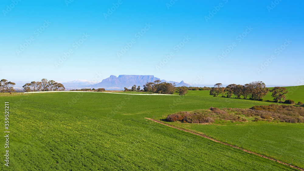 Fototapeta premium Cape Town, Western Cape / South Africa - 07/24/2017: Aerial photo of Malmesbury Farming Fields with Table Mountain in the background
