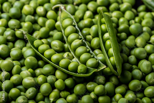 Fresh young  green peeled peas background