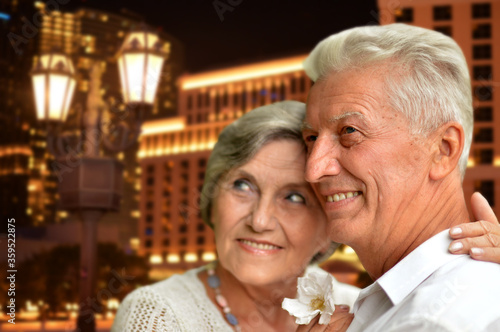 Happy senior couple posing against Las Vegas city