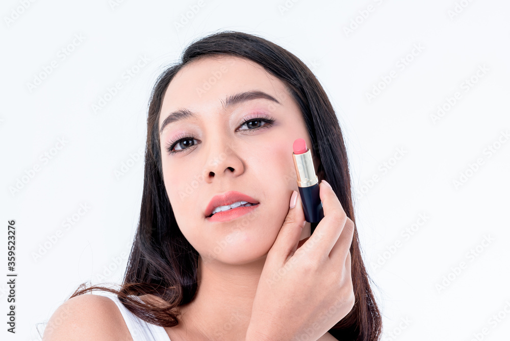 Portrait images of Asian young, pretty woman is 25 years old are holding lipstick On white background, to people and beauty concept. Portrait images of Asian young, pretty woman is 25 years old are holding lipstick On white background, to people and beauty concept.