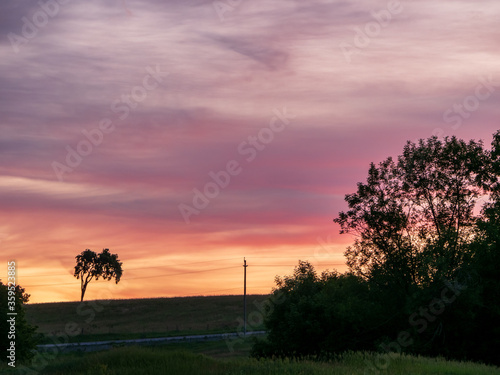 Fototapeta Naklejka Na Ścianę i Meble -  pink and orange sunset near road
