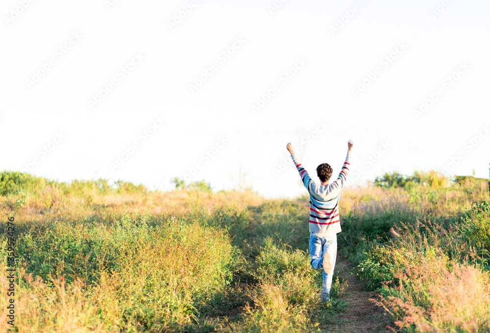 Feeling like a superhero. Young man running happily across the field, feeling free and having fun like a superhero flying. Feeling like a superhero. Young man running happily across the field, feeling free and having fun like a superhero flying.