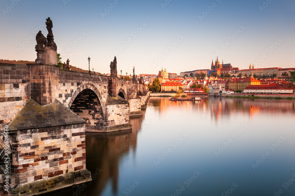View of Old Town with Prague Castle and Charles Bridge at sunrise in Prague, Czech Republic. Famous travel destination