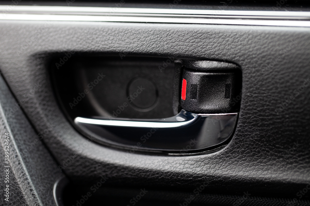 Closeup view of door lock and door lock lever. Vehicle security device.