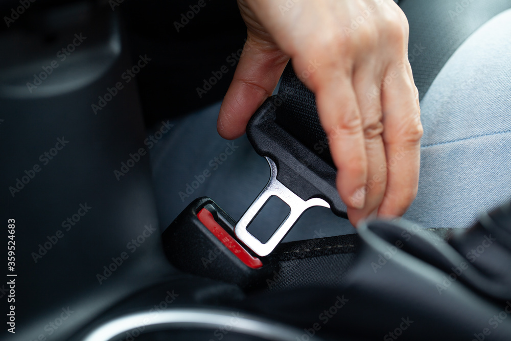 Fastening seatbelt on vehicle. Drive save. Fastening seatbelt on vehicle. Drive save.