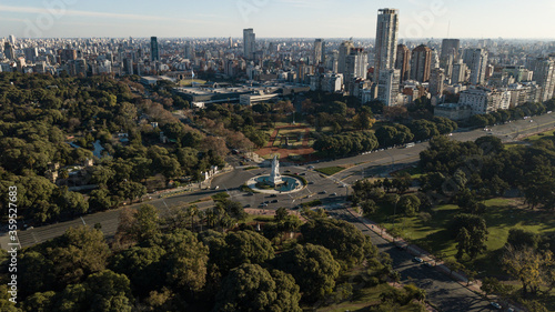 Aerial view on the empty big avenue and roundabout in between of the public parks and gardens, during the sunset and quarantine due to coronavirus, Buenos Aires, Argentina