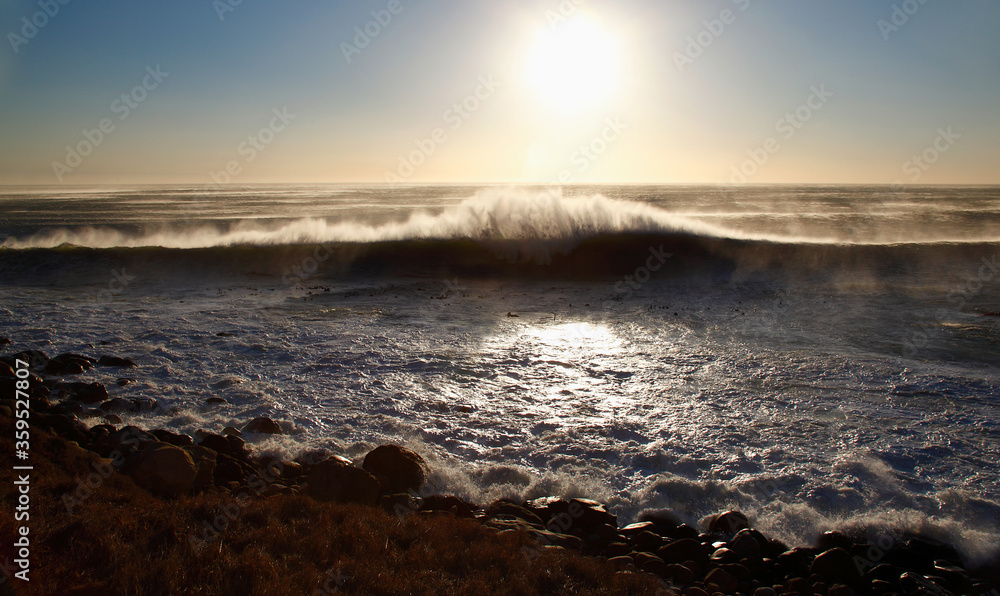 Cape Town, Western Cape / South Africa - 04/15/2011: Waves crash on a beach at sunset
