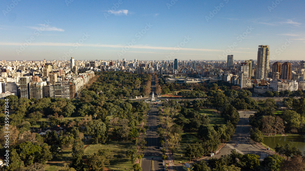 Aerial view on the empty big avenue (due to coronavirus quarantine) in between of the public parks and gardens with the statue in the middle of the roundabout, Palermo, Public Parks, Buenos Aires