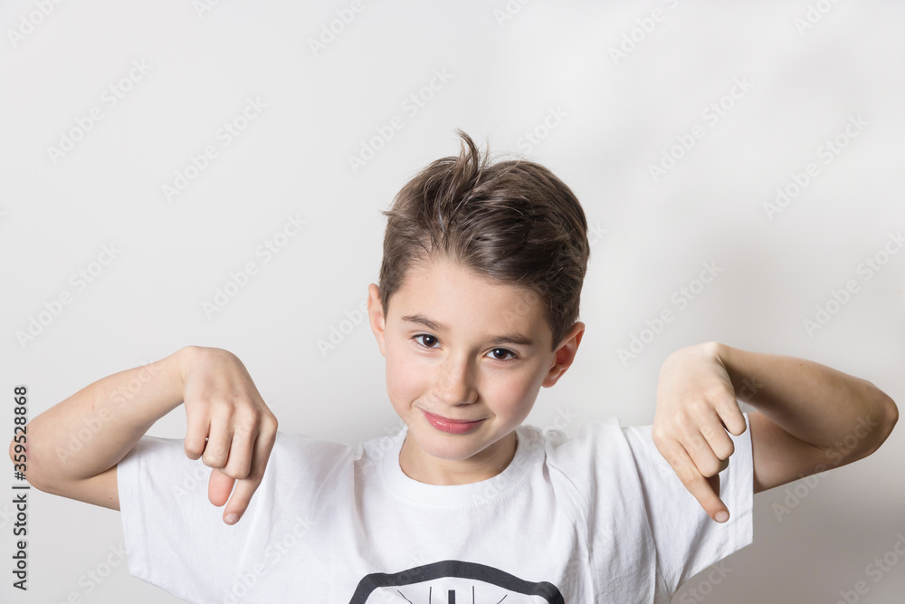 Teenage boy in white shirt. Portrait in studio. Funny faces.