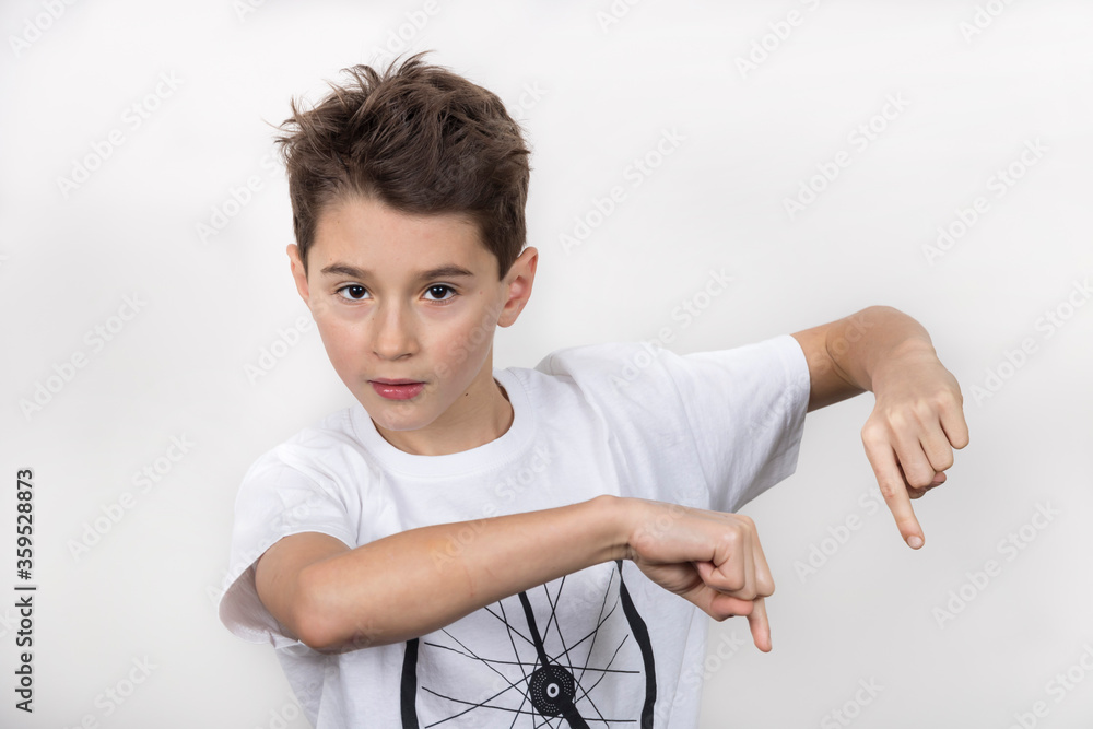 Teenage boy in white shirt. Portrait in studio. Funny faces.