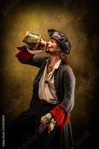Portrait of a pirate in profile, drinking rum from a jug