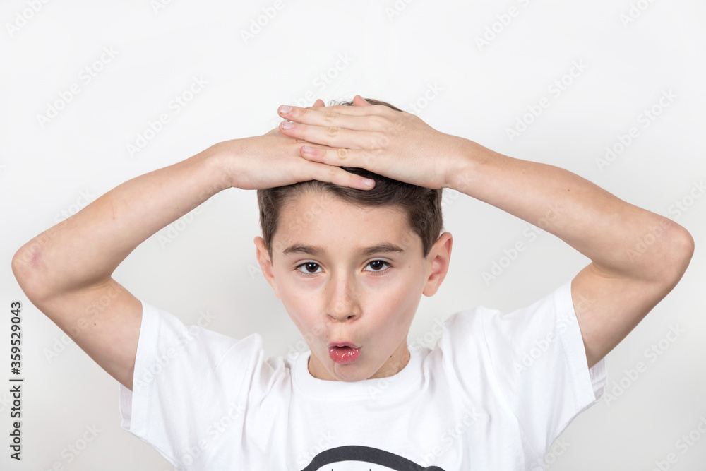 Teenage boy in white shirt. Portrait in studio. Funny faces.