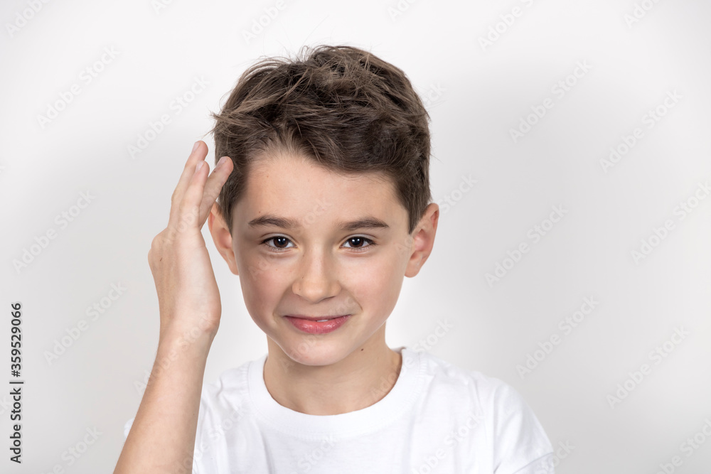 Teenage boy in white shirt. Portrait in studio. Funny faces.