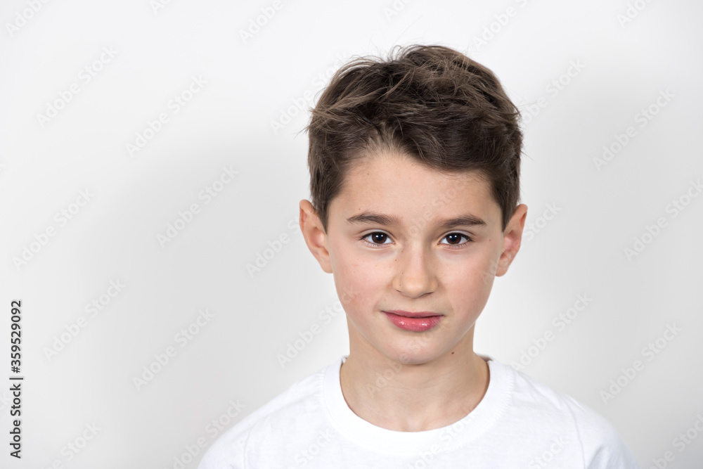 Teenage boy in white shirt. Portrait in studio. Funny faces.