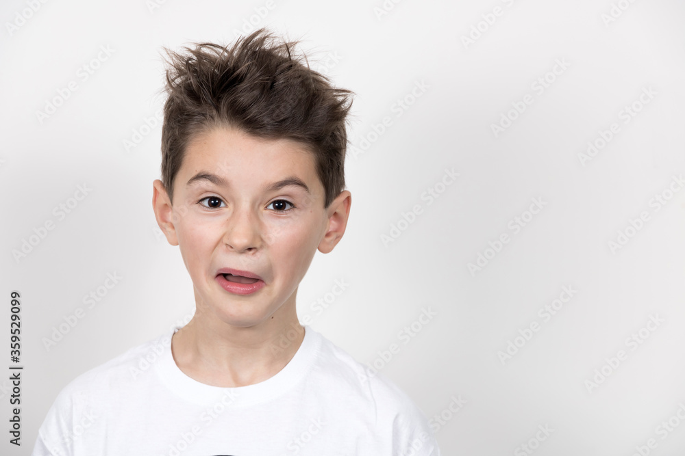 Teenage boy in white shirt. Portrait in studio. Funny faces. Teenage boy in white shirt. Portrait in studio. Funny faces.