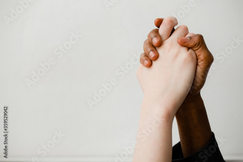 The fight against racism. Two hands of different nationalities compress each other as a sign of support and solidarity. photo