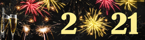 HAPPY NEW YEAR 2021 - Festive silvester background panorama banner long - Golden yellow firework, sparkler and two champagne classes toasting on black night texture