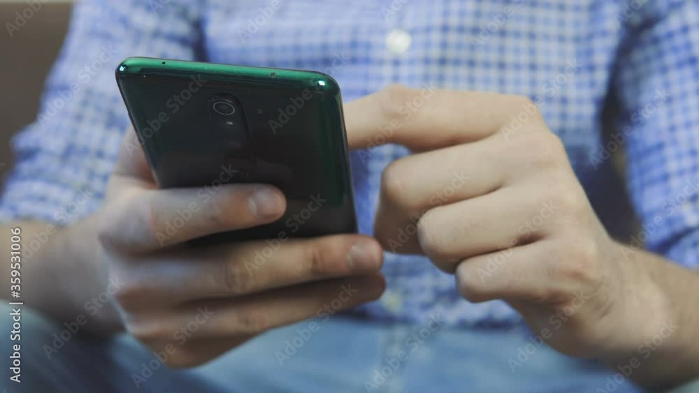 Close up shot - young man surfing net using mobile phone at home office. Close up woman hands using smartphone on couch. Close up shot - young man surfing net using mobile phone at home office. Close up woman hands using smartphone on couch.
