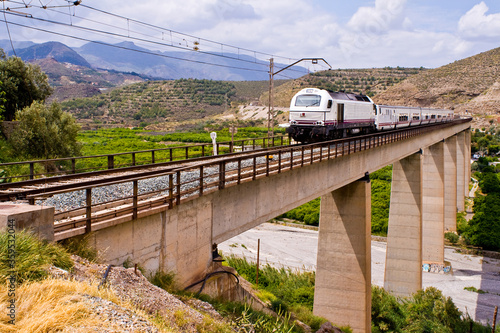 Tren español sobre un puente. Puente de Santa Fe de Mondujar, Almería, España. photo