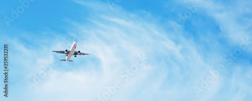 Fotografia Panoramic Background with flying plane in blue sky