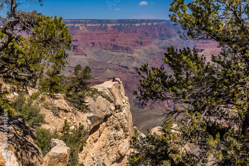 Sitting on a ledge high above the South Rim of the Grand Canyon, Arizona in springtime