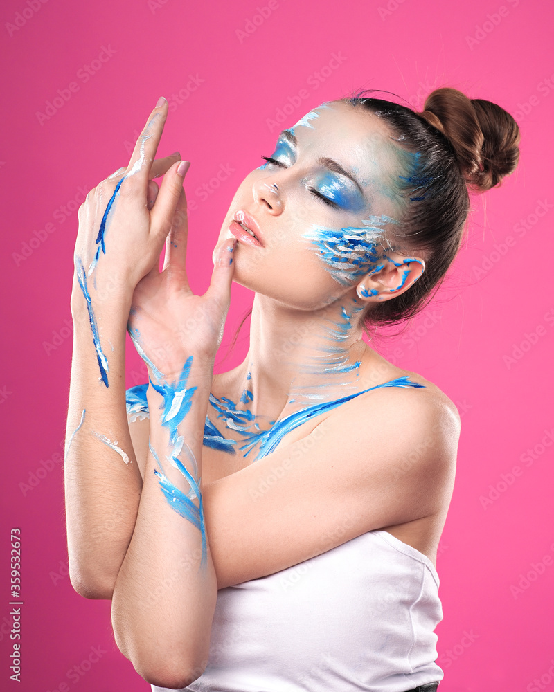 Girl with art make up posing at pink background Girl with art make up posing at pink background