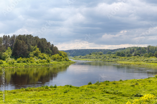 Fototapeta Naklejka Na Ścianę i Meble -  Beautiful summer day by the river, thunderclouds, Kraslava, Latgale, Latvia