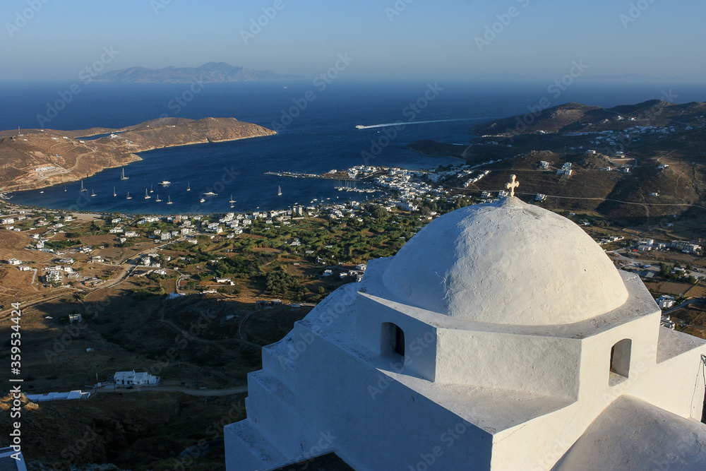 Serifos, Cyclades islands, Greece: the dome of the Agios Athanasios church  in closeup, the port of Livadi in background 