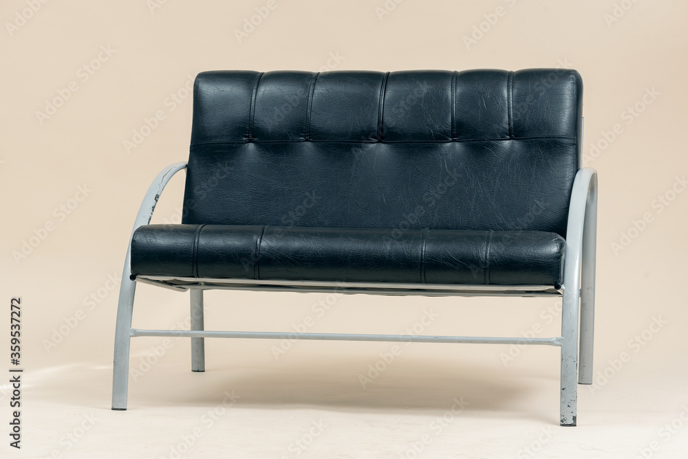 Black leather sofa on a light background. Black leather sofa on a light background.
