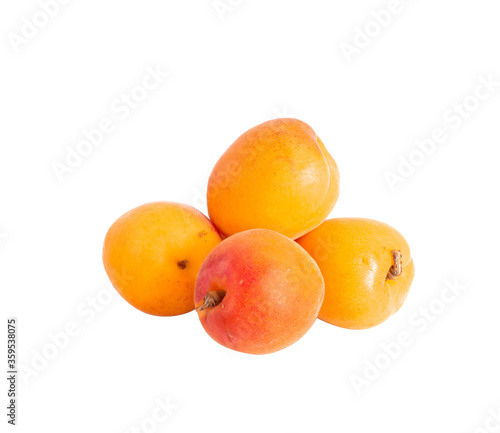 Few whole ripe orange apricots on white background