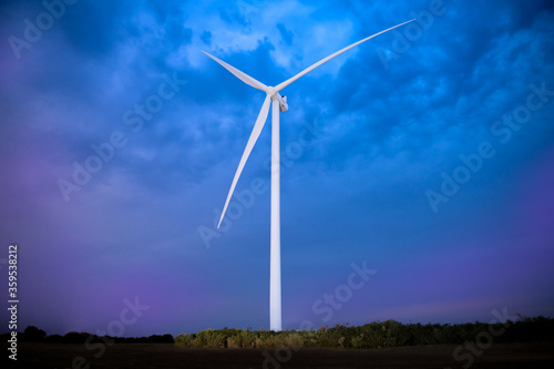 Wind farm windmill at dusk with dramatic background. © Gregory