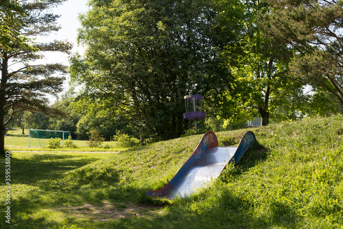 Girl throwing disc golf against basket
