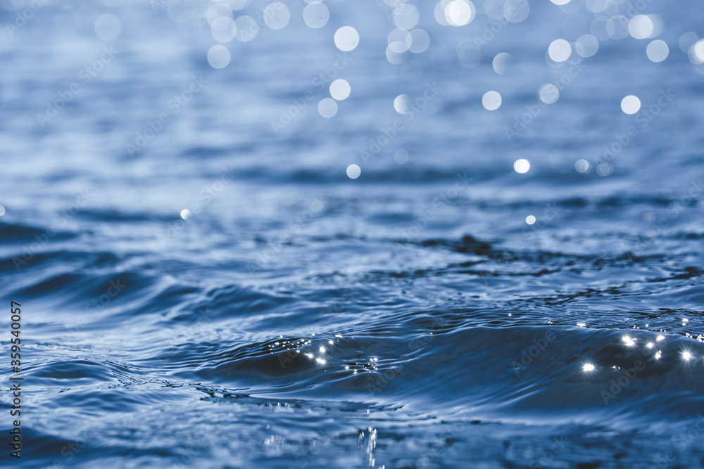 Abstract blue water sea for background. close up, low angle view. Lights on ocean waves Abstract blue water sea for background. close up, low angle view. Lights on ocean waves