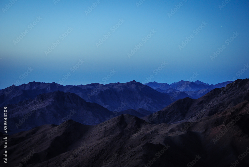 Mountains in the morning. Dark blue tones. Minimalism and gadient wallpaper.