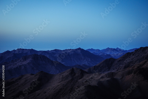 Mountains in the morning. Dark blue tones. Minimalism and gadient wallpaper.