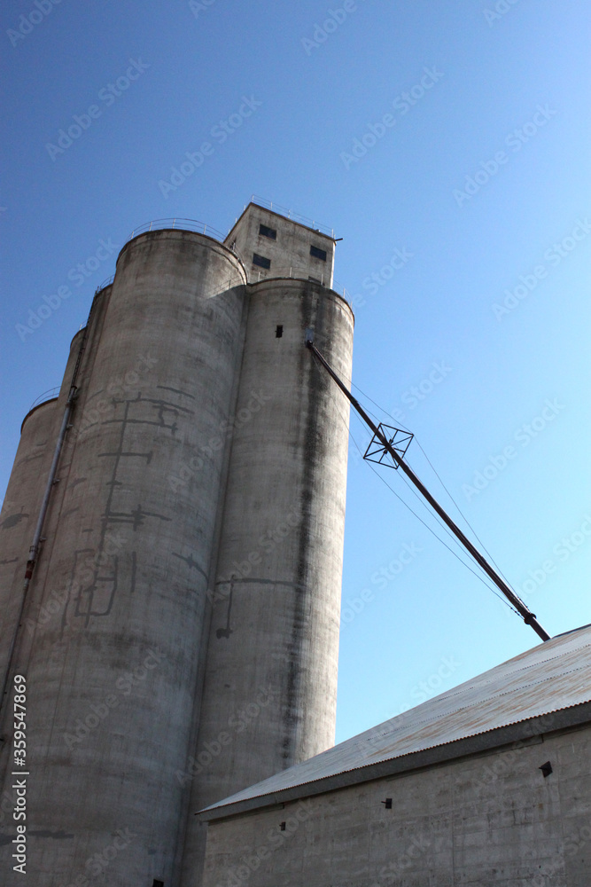 Grain elevators and silos with sky and clouds from different perspectives