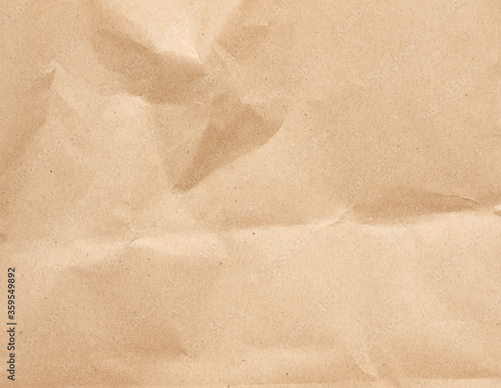 Naklejka premium crumpled blank sheet of brown wrapping kraft paper
