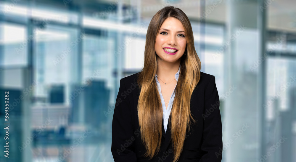 Smiling businesswoman portrait in a modern office Smiling businesswoman portrait in a modern office