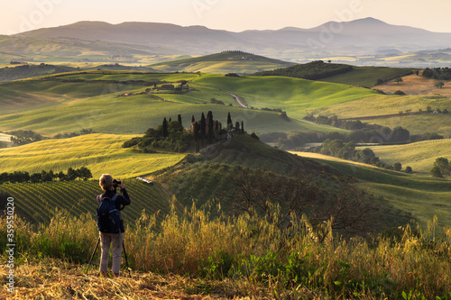 Photographing at sunrise beautiful Tuscany landscape with traditional farm house  hills and meadow. Val d orcia  Italy.
